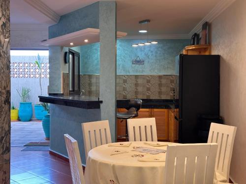 a dining room with a table and chairs at Hotel L'Initiale in Oualidia