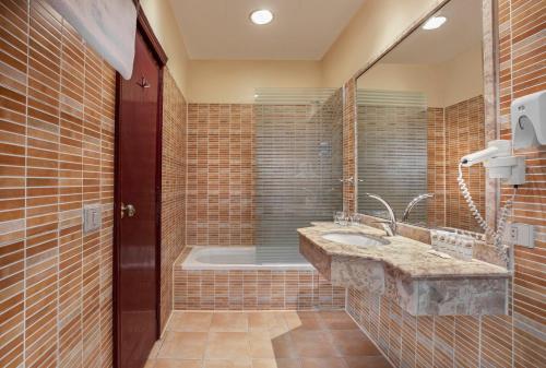 a bathroom with a sink and a bath tub at Holidays Express Hotel in Cairo