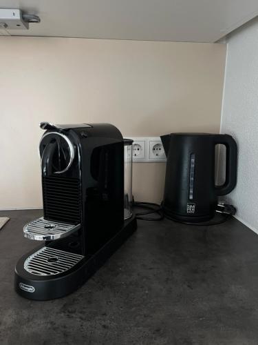 a coffeemaker and coffee maker sitting on a counter at Bestezeit Appartements in Schladming