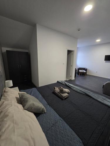 a bedroom with a bed with a pair of shoes on it at Stari Vuk in Belgrade