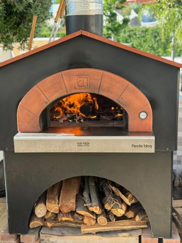 a wood fired oven with fire inside of it at Hotel Parco Delle Agavi in Ischia