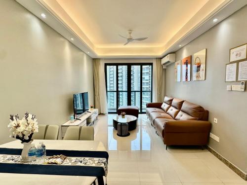 a living room with a couch and a table at R&F Seine Region in Johor Bahru