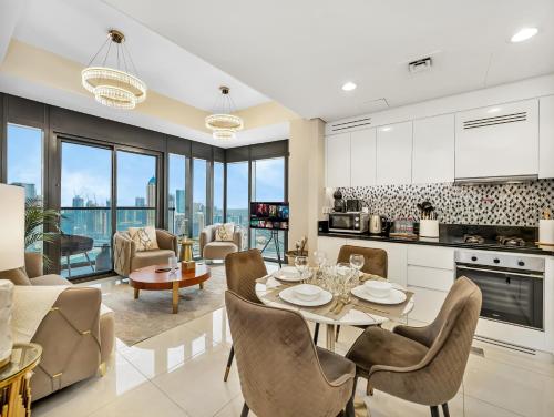 a kitchen and living room with a table and chairs at Lux Apartments in BusinessBay, Canal views, Great Location in Dubai