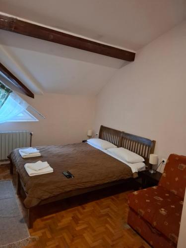 a bedroom with a bed and a chair at Hotel Koliba na Grza in Kilsura