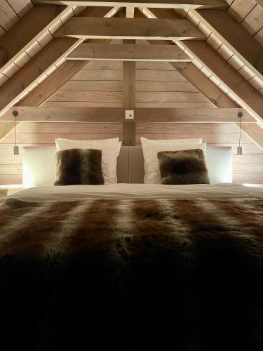 a bedroom with a large bed in a attic at La Perle du Fierain in Wegnez