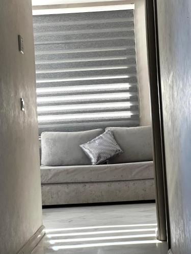 a view of a couch through a window at Prestigia luxury appartement in Fès