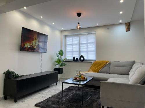 a living room with a couch and a table at ADVENTURE LuxusApartment in Wetzlar