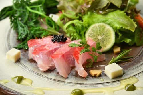 a plate of food with meat and vegetables on a table at Eirakukan in Koriyama