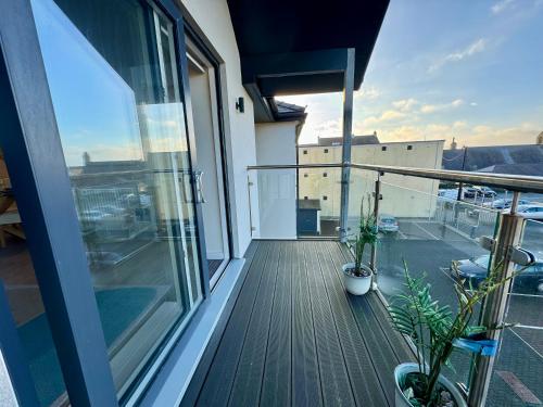an apartment balcony with a view of a building at Gwel Y Bae-2 Bed-en-suite-Lift-Pet friendly in Trearddur
