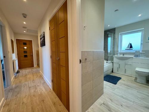 a large bathroom with a toilet and a sink at Gwel Y Bae-2 Bed-en-suite-Lift-Pet friendly in Trearddur