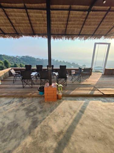 a group of chairs sitting on a wooden deck at Maemon villa แม่มอญ วิลล่า in Ban Ri So