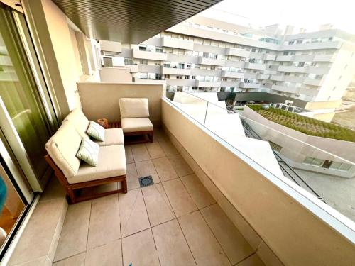 a room with two chairs and a large window at Apartamento Comfort Deluxe in Rivas-Vaciamadrid