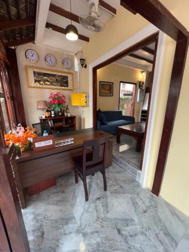 a living room with a desk and a couch at Chaluenxay Legend Hotel in Luang Prabang