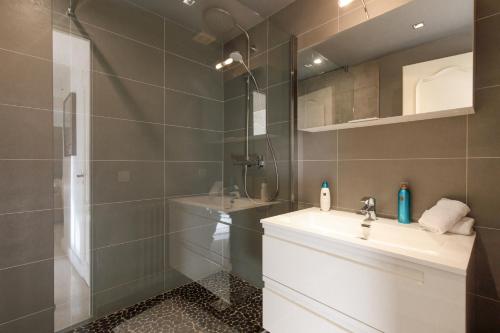 une salle de bain avec un lavabo et une douche dans l'établissement Le Palais Royal Elégant Confortable -Balcon 100 mètres Croisette, à Cannes