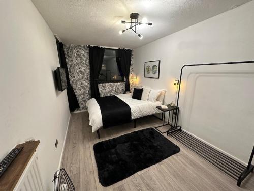 a small bedroom with a bed and a window at Spacious and modern flat in Archway in London