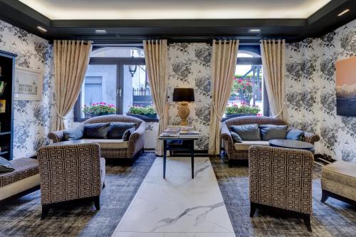 a living room with couches and chairs at Romantik Hotel Mont Blanc au Lac in Morges