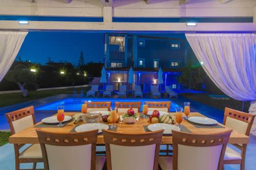 a dining room table with chairs and a tableablish at Villa Shameti - Private Villa with Pool and Billiards Near Zakynthos Town By Villa Mana Gers in Zakynthos Town