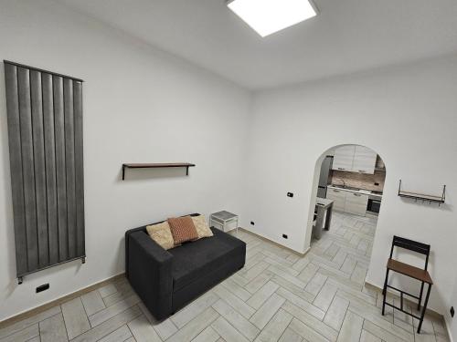 a living room with a couch and a chair at Vanessa Home - Roma in Infernetto