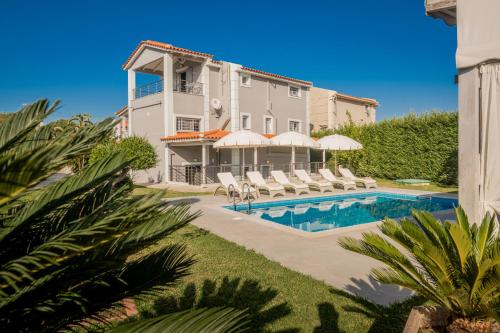 a villa with a swimming pool in front of a building at Villa Shameti - Private Villa with Pool and Billiards Near Zakynthos Town By Villa Mana Gers in Zakynthos Town