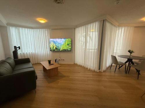 a living room with a couch and a table at CBD Two Bedrooms Apartment in Brisbane