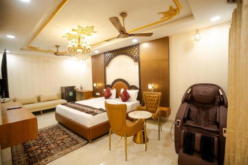 a hotel room with a bed and a couch at RAJWADA RESORT & HOTEL in Raipur