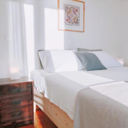 a bedroom with two beds and a wooden dresser at KALAMIES - Secluded Beach Apartments in Skala