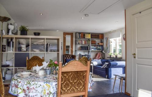 a living room with a table and a couch at 1 Bedroom Cozy Apartment In Brantevik in Brantevik