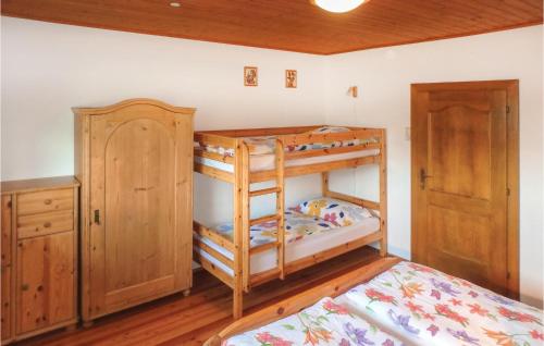 a bedroom with two bunk beds and a wooden cabinet at Ferienwohnung Klein St Paul in Eberstein
