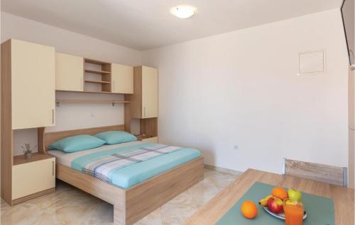 a small bedroom with a bed and a bowl of fruit at Studio Apartment In Krvavica in Krvavica