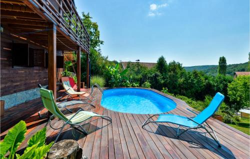 a deck with chairs and a swimming pool at Gorgeous Home In Trstenik Puscanski in Trstenik Pušćanski