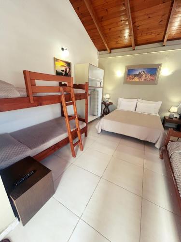 a bedroom with two bunk beds and a television at PEDRO NAVARINO VII Laganas in Laganas