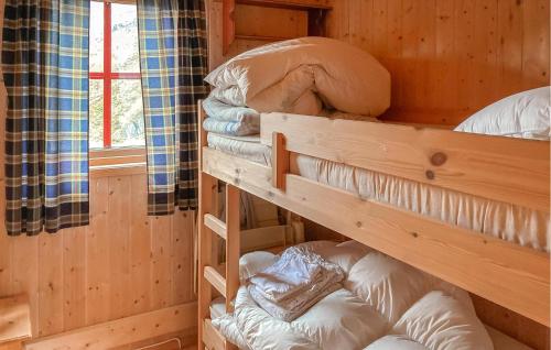 a room with bunk beds in a log cabin at Amazing Home In Dirdal With Wifi in Dirdal