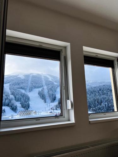 two windows in a room with a view of a mountain at Bjelasnica View Apartment in Bjelašnica