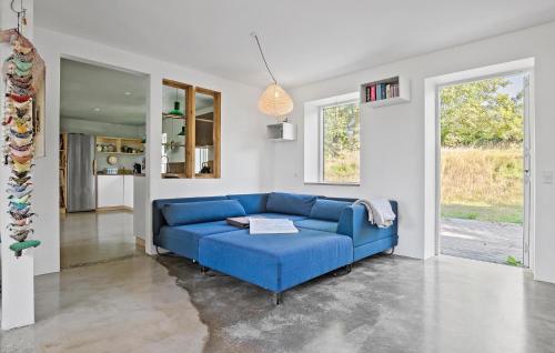 a blue couch in a white living room at 4 Bedroom Beautiful Home In Knebel in Knebel