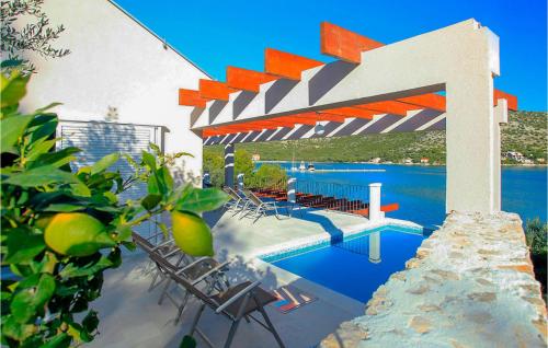 Blick auf einen Pool mit Stühlen und ein Gebäude in der Unterkunft Villa Tapenade in Lastovo