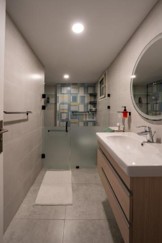 a bathroom with a shower and a sink and a mirror at The Nile Vintage Haven in Cairo