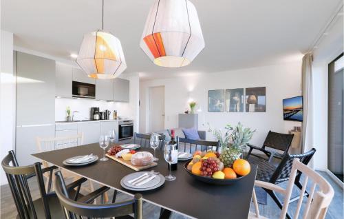 a dining room and kitchen with a table with fruit on it at Penthouse Comfort in Lembruch
