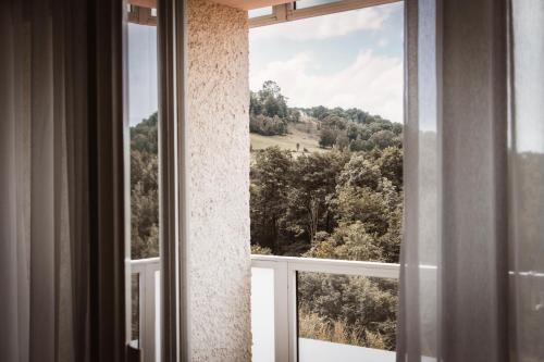 an open window with a view of a mountain at Sure Hotel by Best Western Rhoen Garden in Poppenhausen