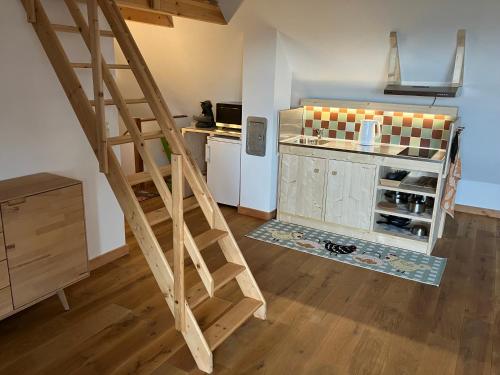a kitchen with a staircase leading up to a kitchen with a counter at In der Wassermühle in Melle