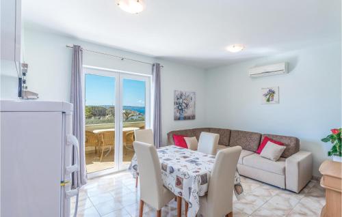 a living room with a table and a couch at Nice Apartment In Povljana With Kitchen in Povljana