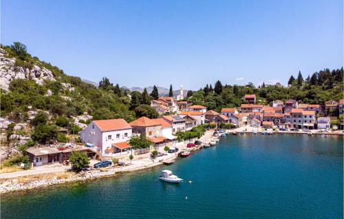 a town on a river with boats in the water at 4 Bedroom Beautiful Home In Rogotin in Rogotin