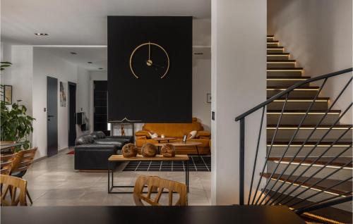 a living room with a couch and a clock on a wall at Stunning Home In Crikvenica in Crikvenica