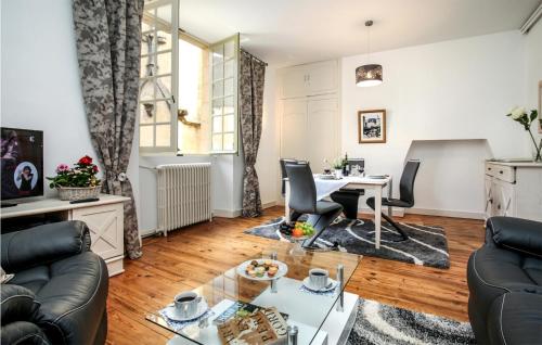 a living room with a table and chairs at St Marie in Sarlat-la-Canéda