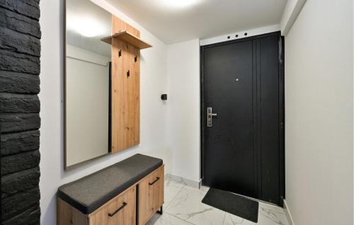a bathroom with a black door and a mirror at Lovely Home In Kunovec Breg With Sauna in Močilski Breg