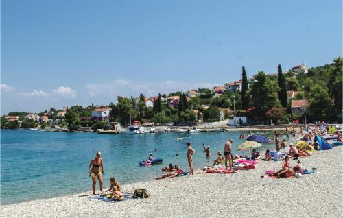 a group of people on a beach near the water at 1 Bedroom Nice Apartment In Necujam in Nečujam