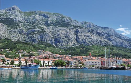 a town on the water with a mountain in the background at Holiday Home Gornji Tucepi-Srida Sela Bb Ii in Tučepi