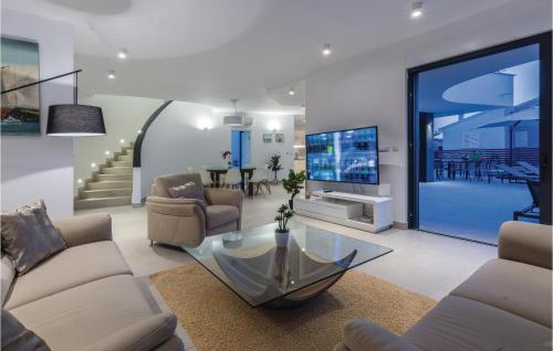 a living room with a couch and a glass table at Amazing Home In Biograd With Kitchen in Biograd na Moru