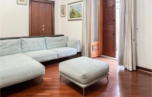 a living room with a couch and a stool at Nice Apartment In Manfredonia With Wifi in Manfredonia