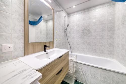 a bathroom with a sink and a tub and a shower at Escapade de Prestige à disneyland & Paris in Torcy