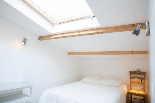 a bedroom with a bed and a skylight at Le Loft in Honfleur